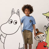 Child wearing a light blue T-shirt and khaki shorts with Moomin figures.