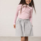 Wearing a blue chino bottom and a bright red t-shirt.