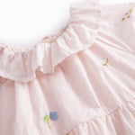 Short-sleeved baby dress with pretty floral embroidery, short sleeves, and collar.