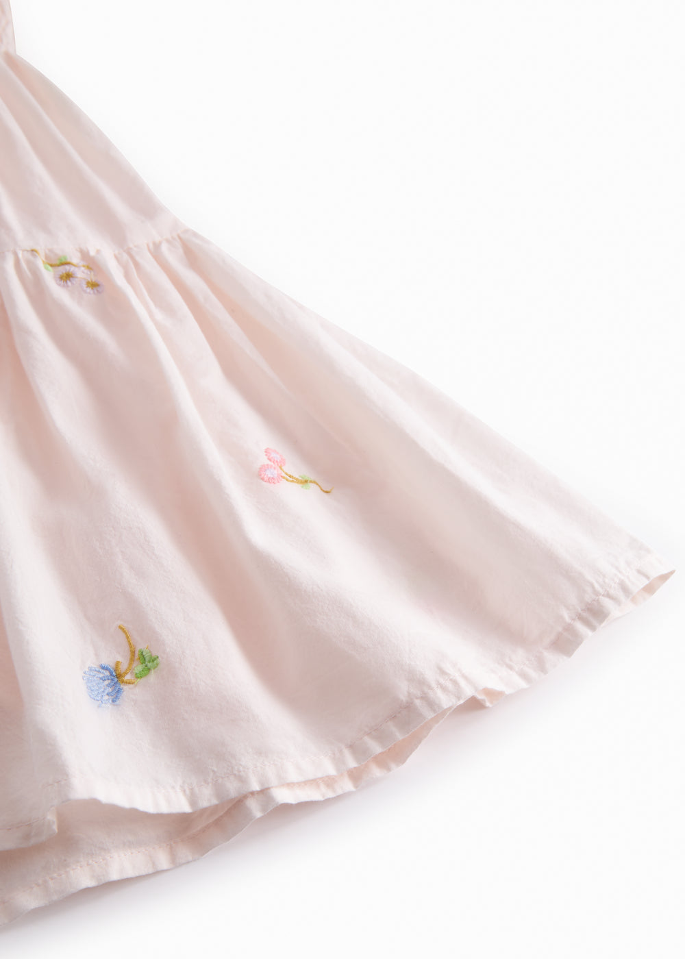 Red short-sleeved layered dress for children with a fine floral embroidery, puff sleeves, and smock effect.