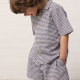 Children wearing a t-shirt and matching shorts.