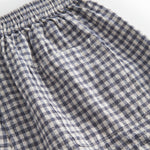 Sort and white net shorts for children with side pockets, elastic in the waist, and a pocket at the back.