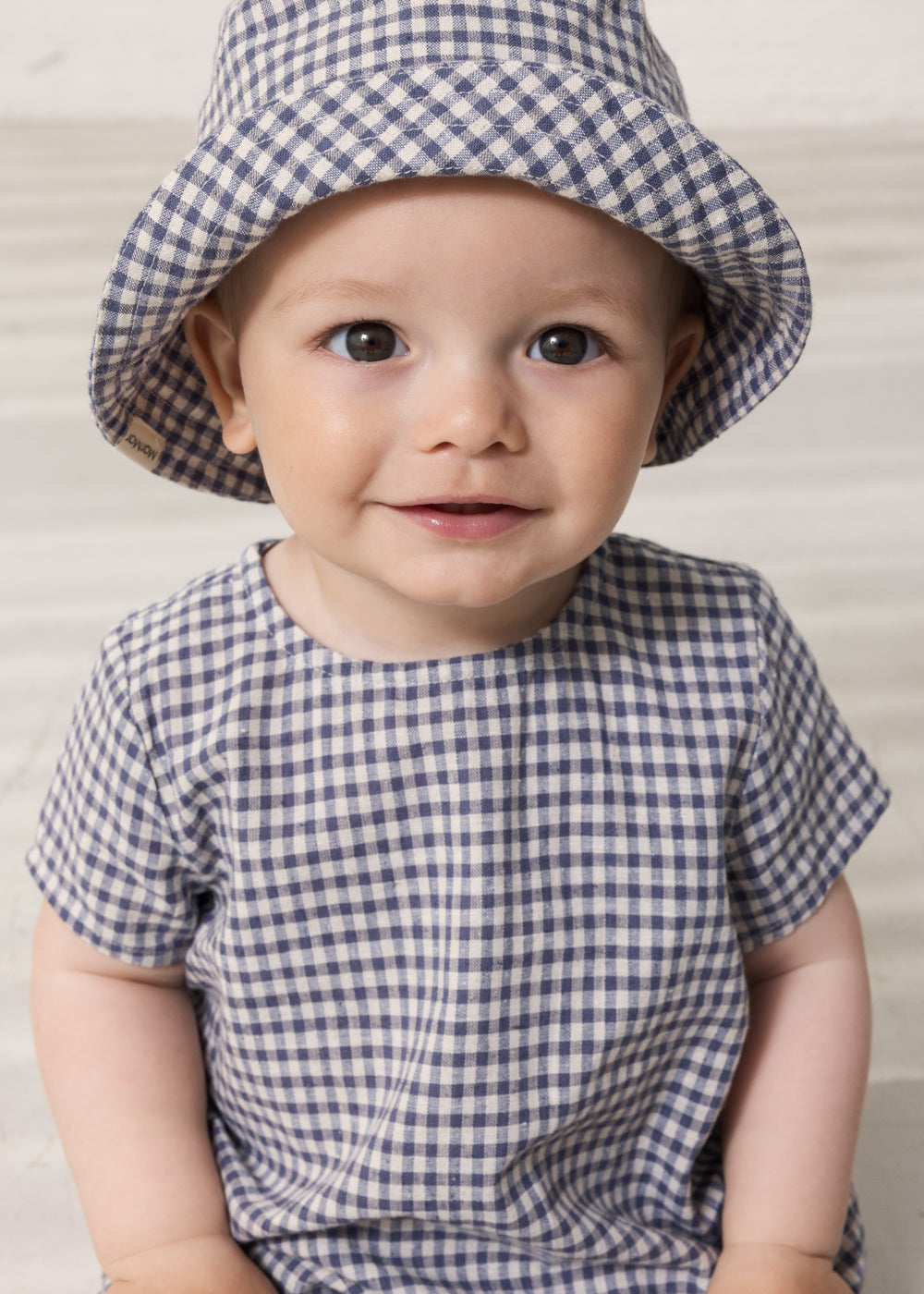 Baby wearing a beanie and a turtleneck set.