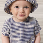 Baby wearing a beanie and a turtleneck set.