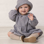 Baby wearing a long-sleeved tunic and hat.