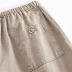 Gray children's jacket with a round neck, two buttons in front, and fine pleated details.