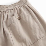 Gray pants for children with elastic at the waist and pockets on the back with buttons.