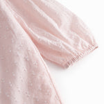 Red children's dress with long sleeves and ruffled collar.