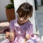 Girl in a light red dress with stripes