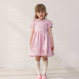 Girl in a light red dress with stripes