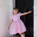 Girl in a light red dress with stripes
