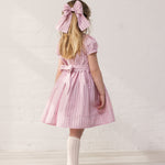 Girl in a light red dress with stripes