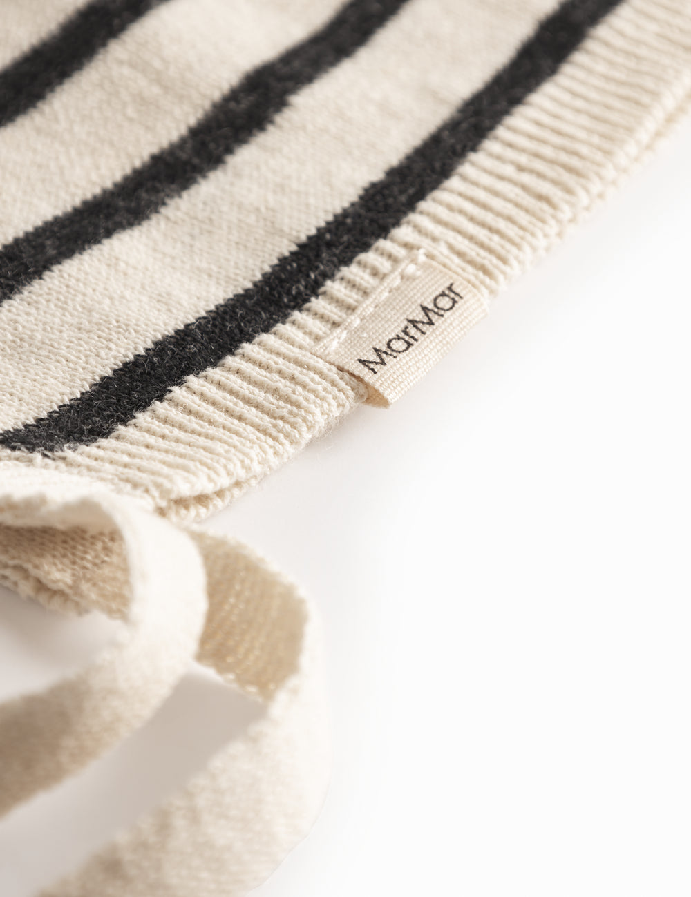 White and black baby booties with ribbons.