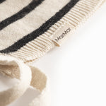 White and black baby booties with ribbons.