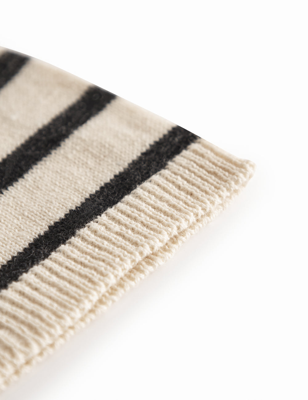 White and black baby booties with ribbons.