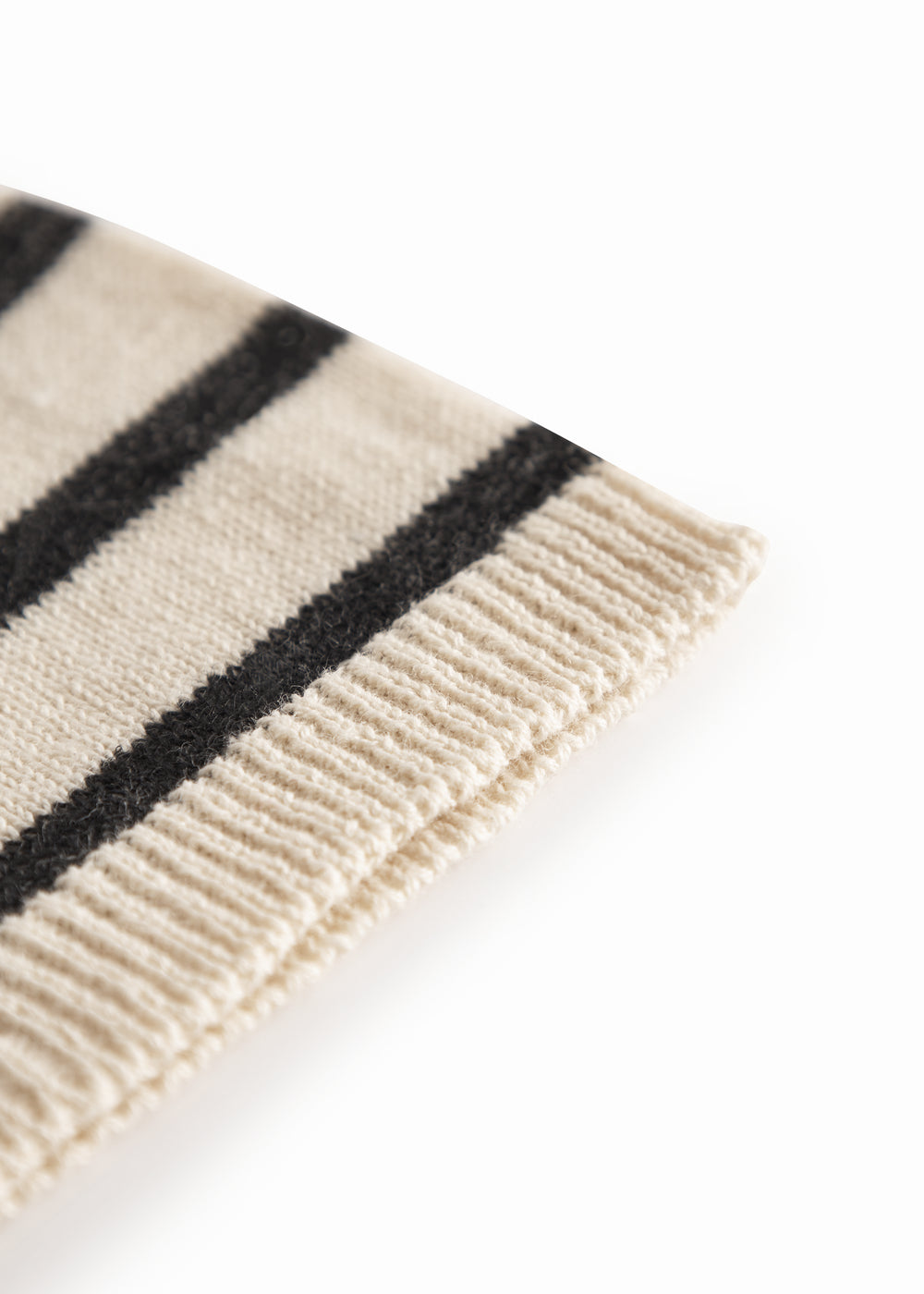 White and black baby booties with ribbons.