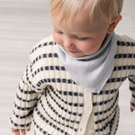Baby worn striped cardigan with round neck, stripes, and button-up closure.