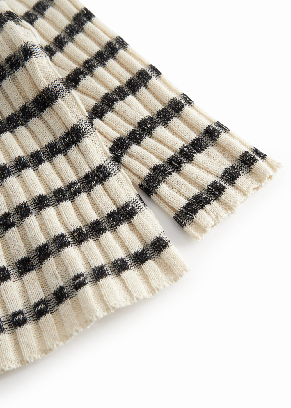 Striped baby cardigan with round neck, stripes, and button closure.