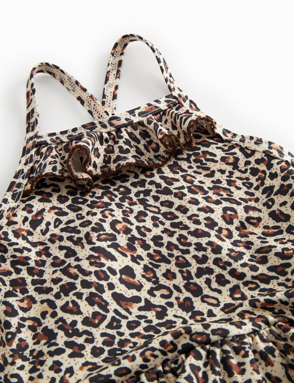 Bathroom wear for children with leopard pattern, narrow straps, and front flap.