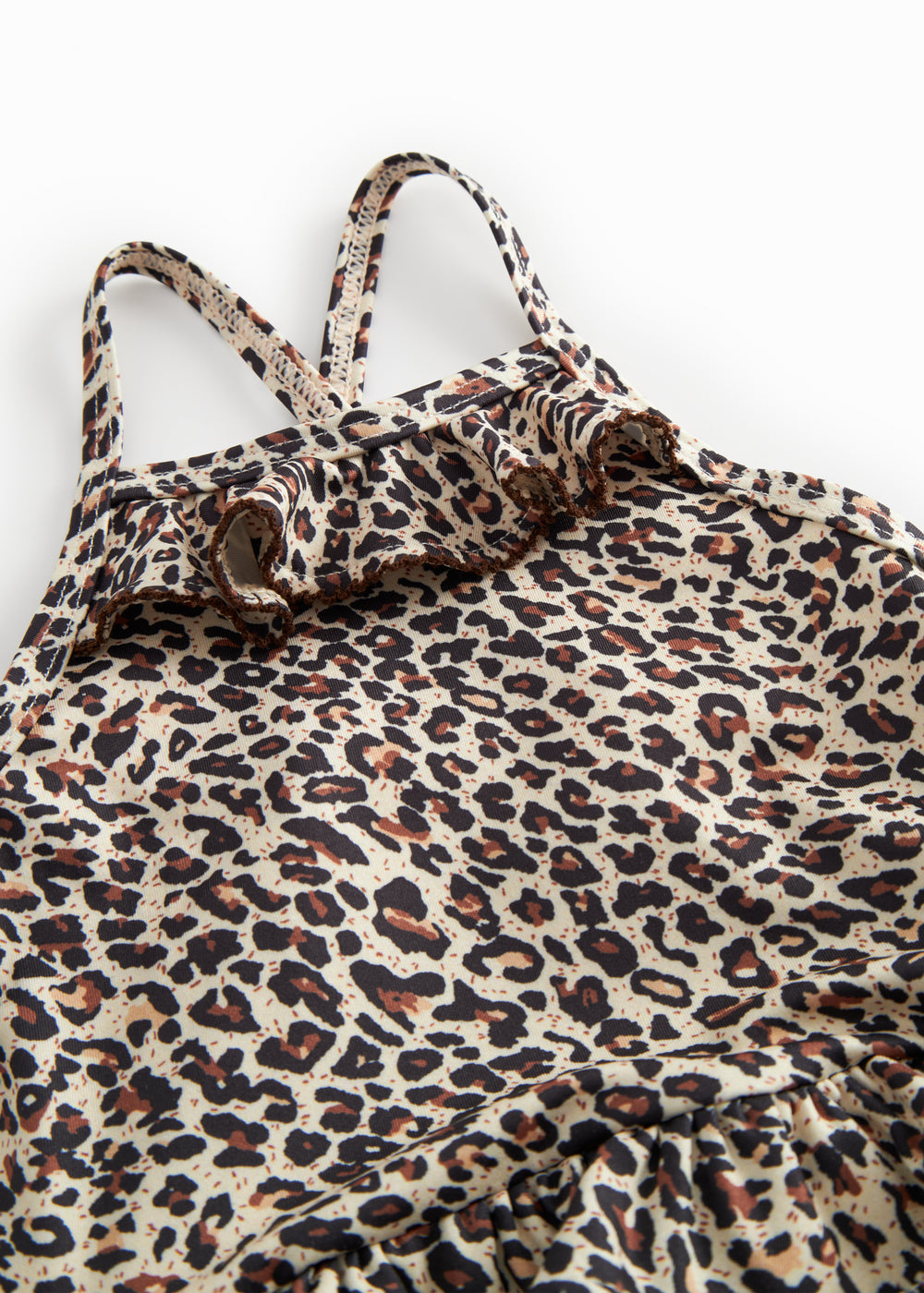 Bathroom wear for children with leopard pattern, narrow straps, and front flap.