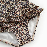 Bathroom wear for children with leopard pattern, narrow straps, and front flap.