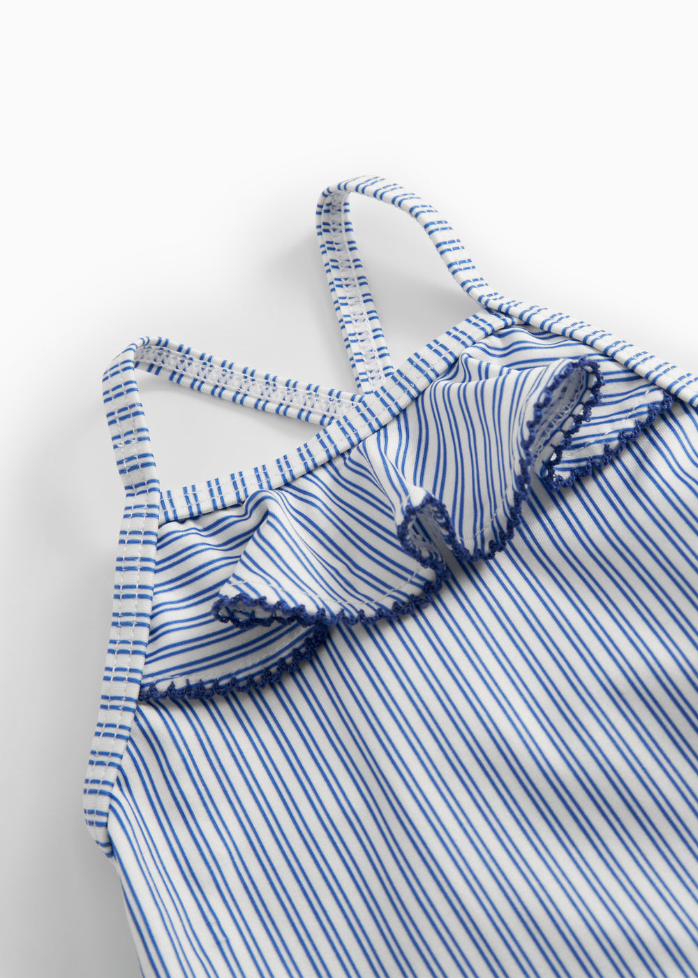 Children's swimwear with blue stripes and ruffles.