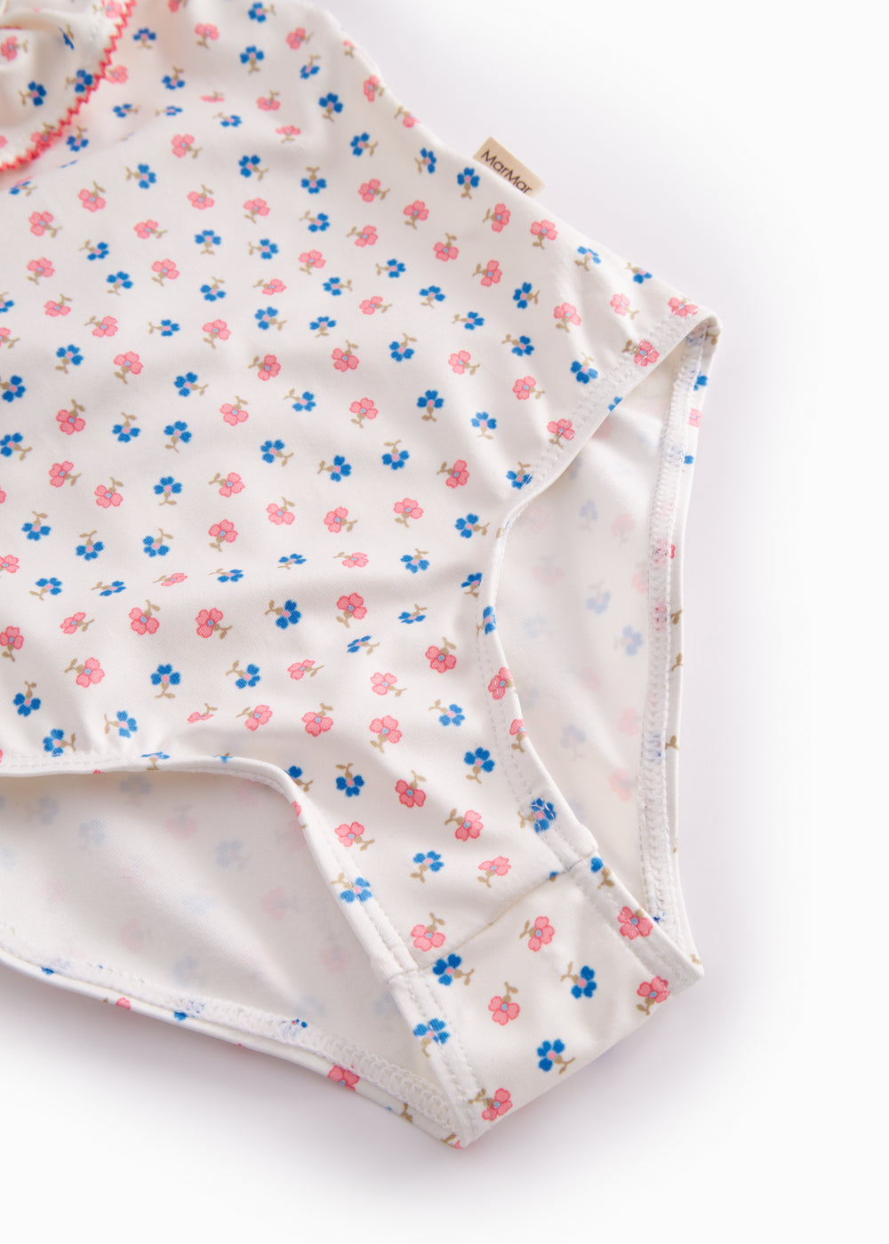 Children's swimwear with a floral pattern and flounces.