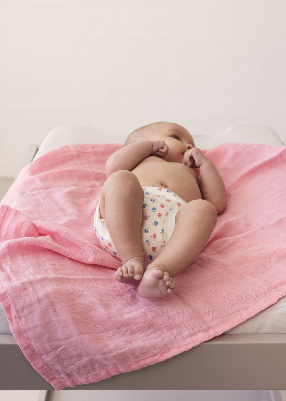 Baby lying on red fabric