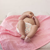 Baby lying on red fabric