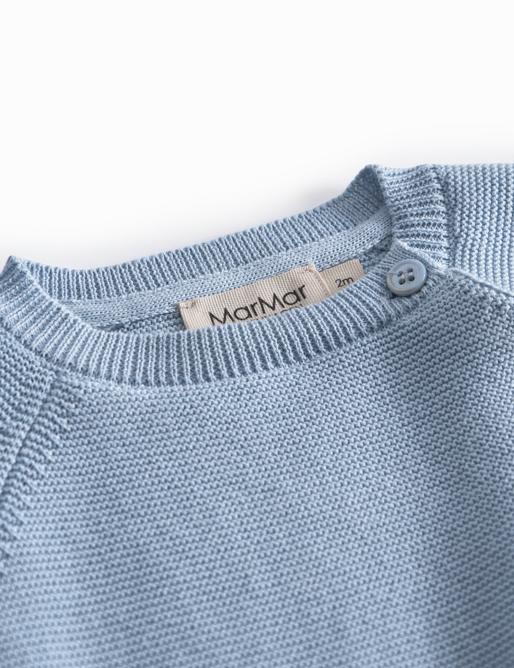 Blue knitted baby blouse with buttons.