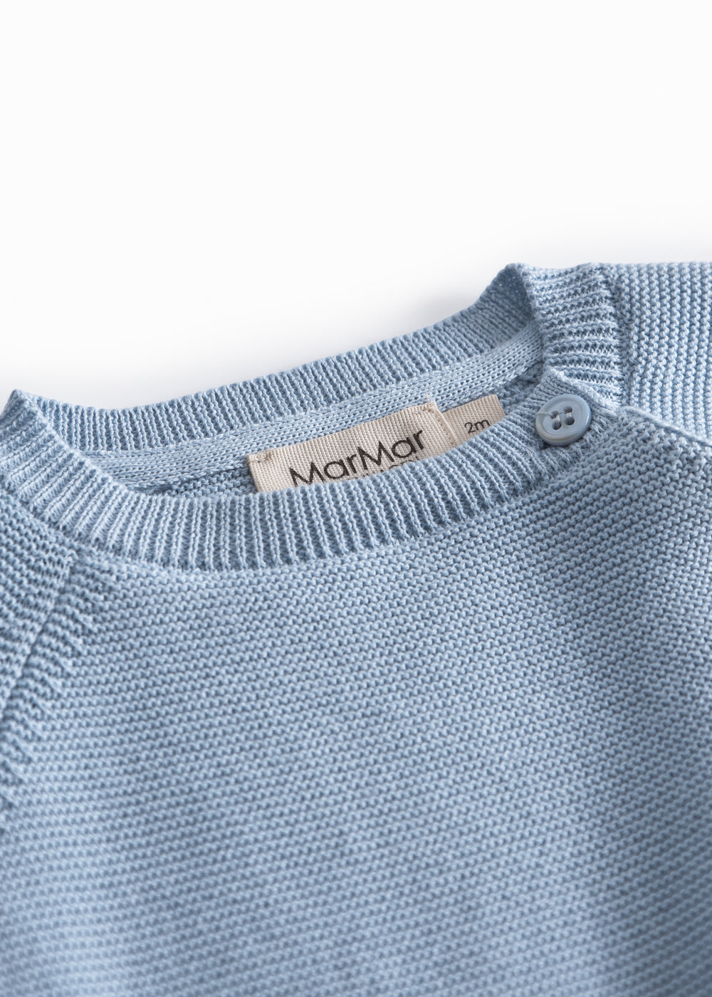 Blue knitted baby blouse with buttons.