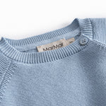 Blue knitted baby blouse with buttons.