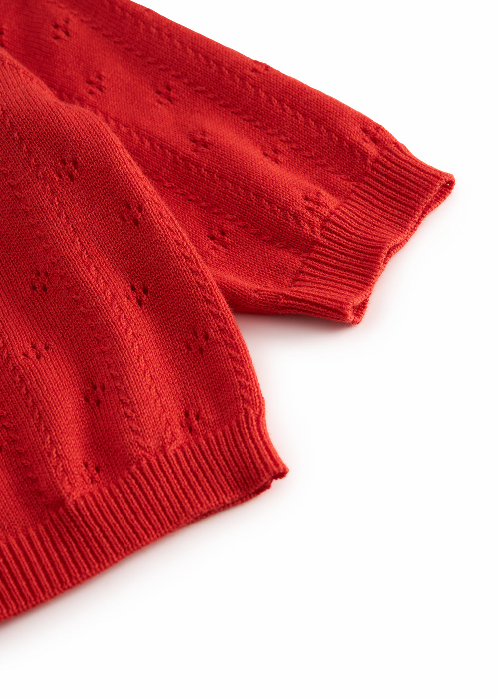 Red striped cardigan for baby, with a pretty lace pattern and button closure.