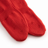 Red baby socks with feet and a fine hole pattern.