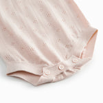 Short sleeve bright red knitted baby bodystocking with a lace pattern and ruffled collar.