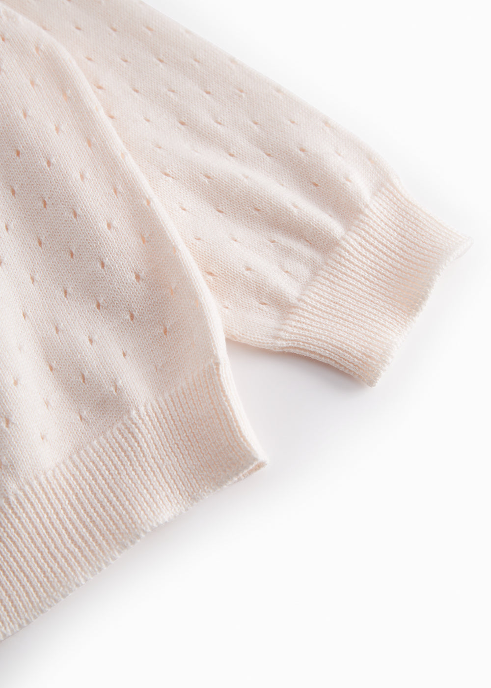 Stylish baby cardigan with a cute pattern and button closure.