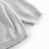 Green striped cardigan for baby, with a pretty lace pattern and button closure.