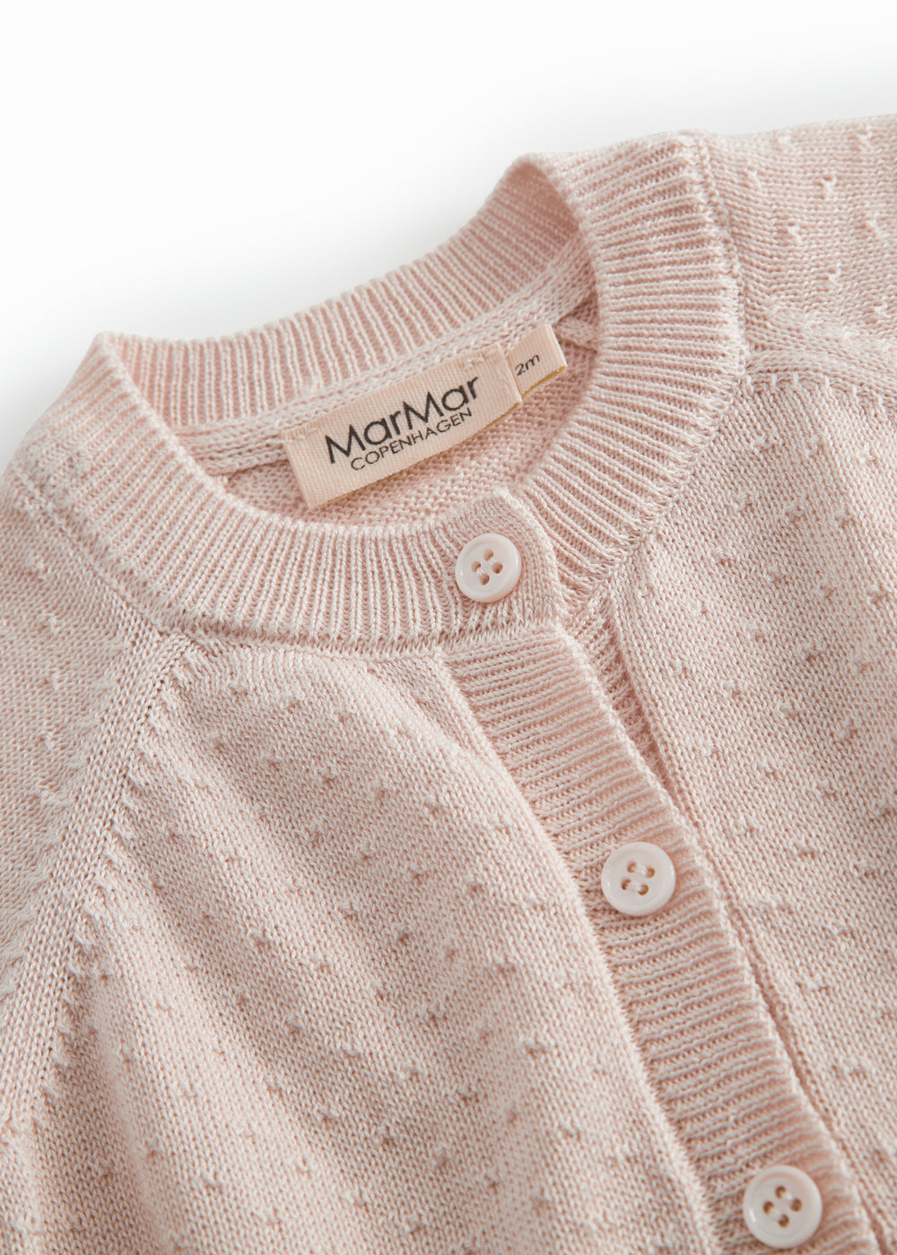 Red striped cardigan for baby, with a pretty lace pattern and button closure.