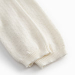 White baby knee pants with a pretty hole pattern.