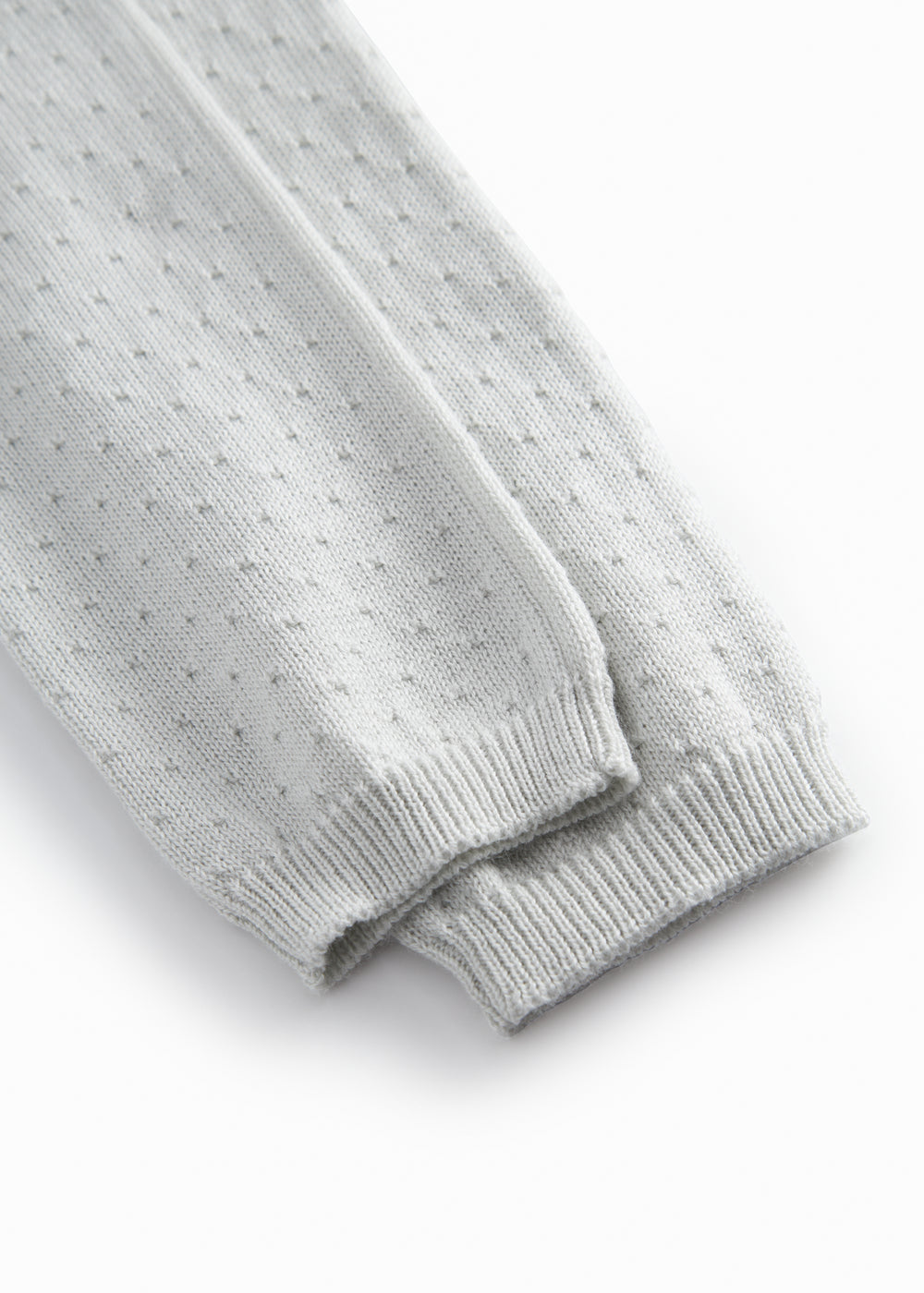 Green baby socks with a fine hole pattern.