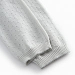 Green baby socks with a fine hole pattern.