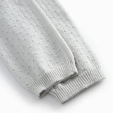 Green baby socks with a fine hole pattern.