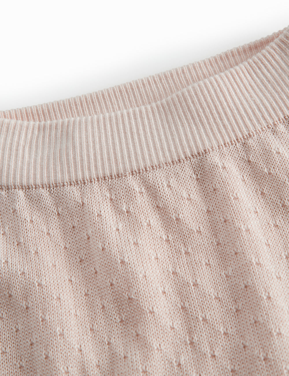 Red baby leggings with a fine hole pattern.