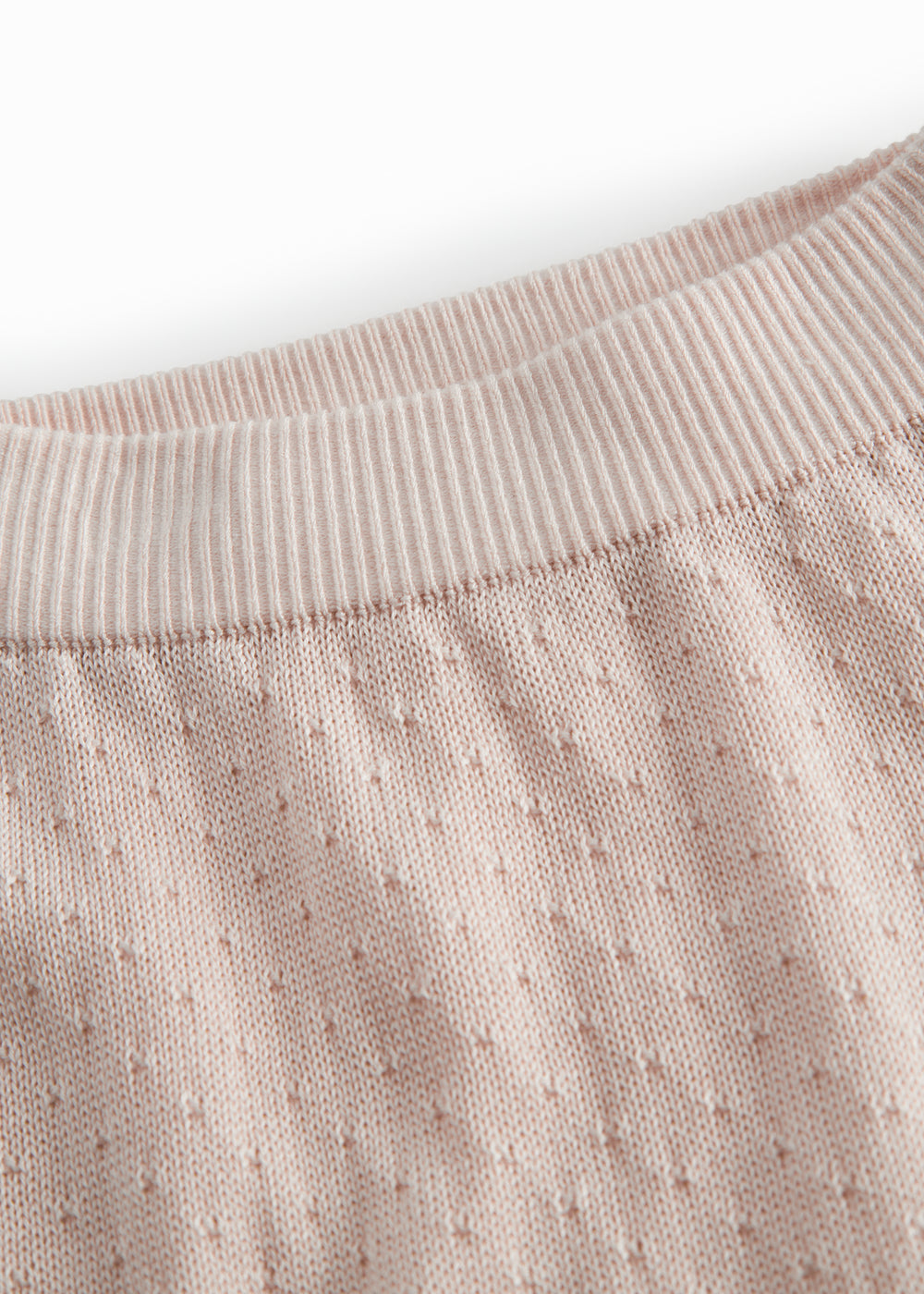 Red baby leggings with a fine hole pattern.