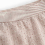 Red baby leggings with a fine hole pattern.