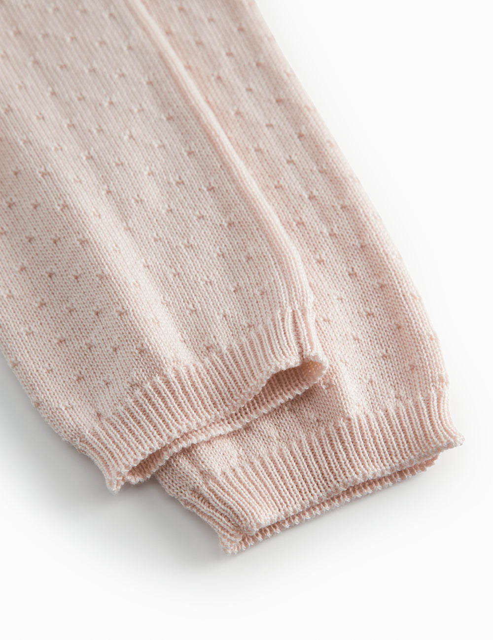 Red baby leggings with a fine hole pattern.