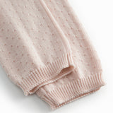 Red baby leggings with a fine hole pattern.