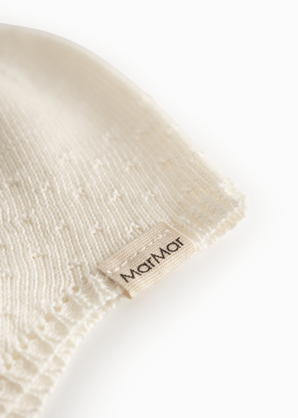 Striped baby hat in white with button closure