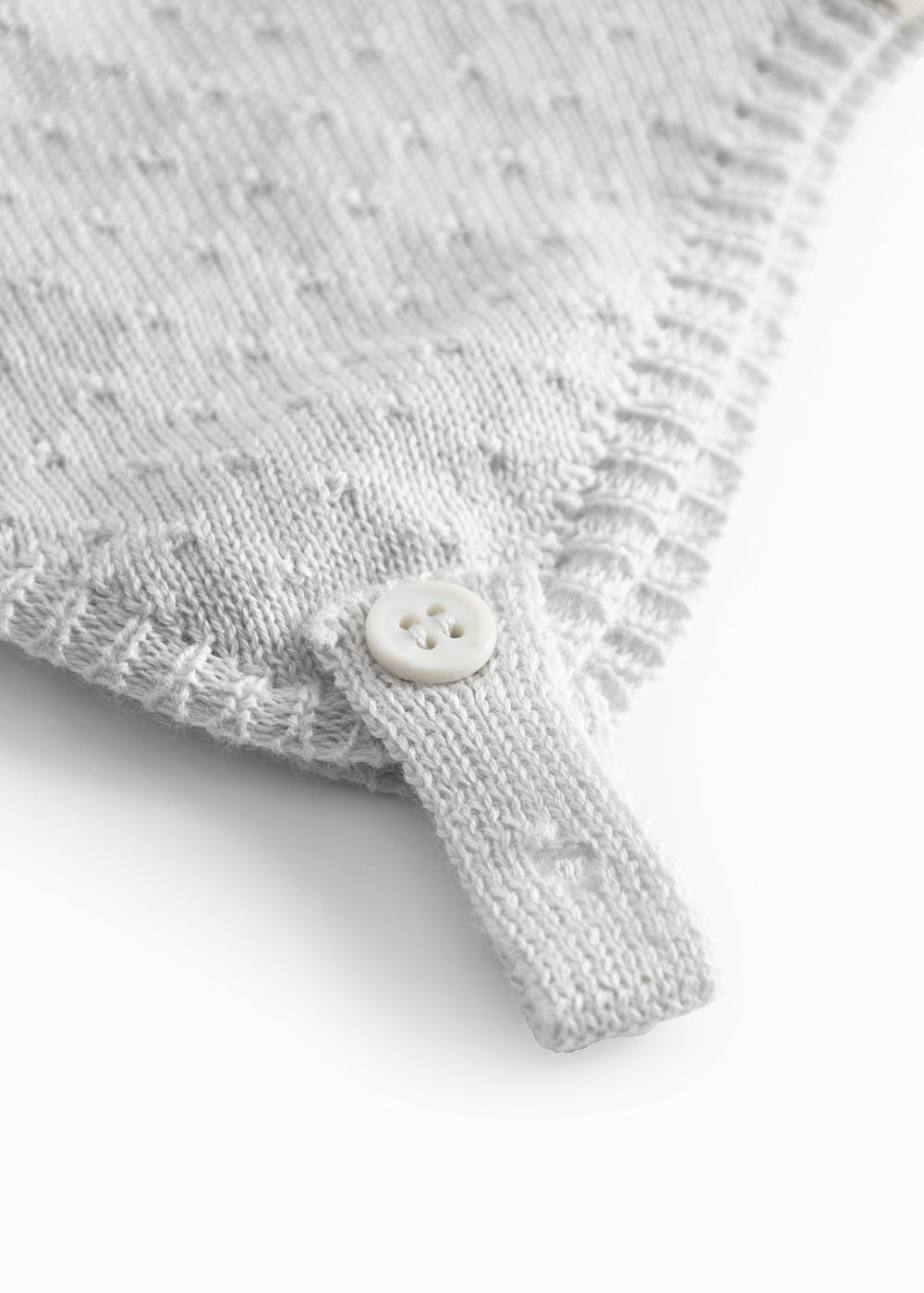 Light green baby hat with a snap closure