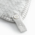 Light green baby hat with a snap closure